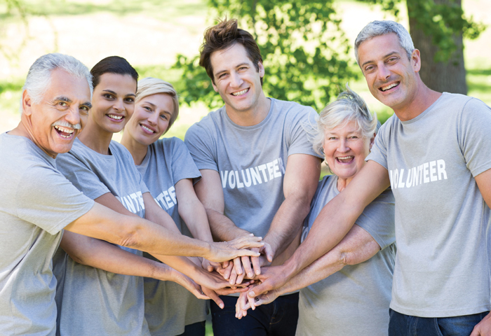 A group of diverse people holding hands