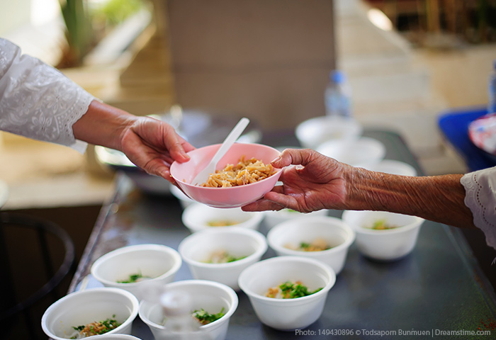 Hands holding a bowl of food