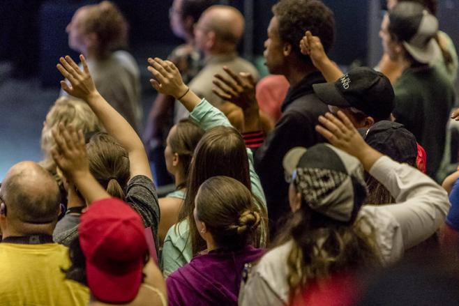 Youth with their hands lifted in worship