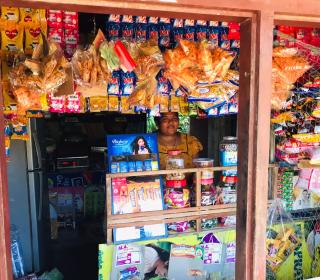 A Sri Lankan woman stands in her retail shop