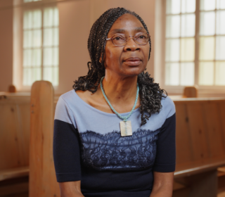 Albertine Chokoté Naoué sitting in a church pew