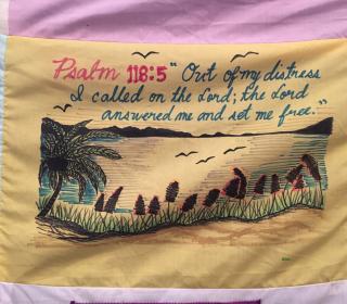 A blanket from the National Inquiry, sharing the poignant words of Psalm 118:5 and a drawing of a shoreline and a lake.