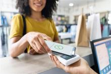 A woman makes a purchase using her phone