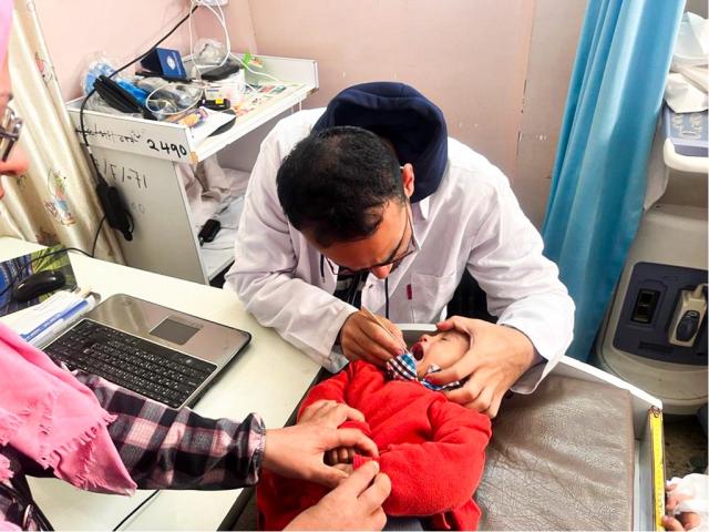 A young child receives treatment in a medical clinic in Rafah