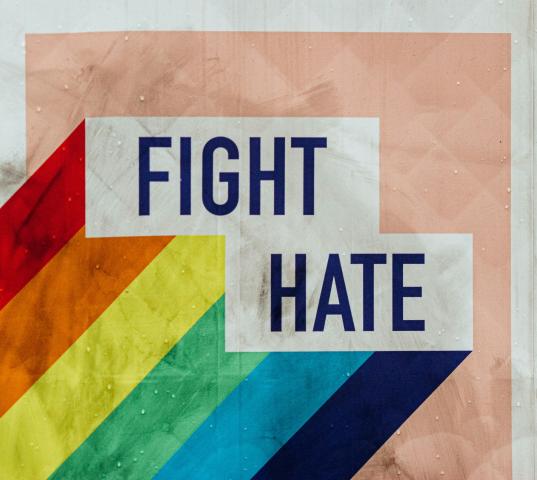 A graphic with a rainbow and the words fight hate