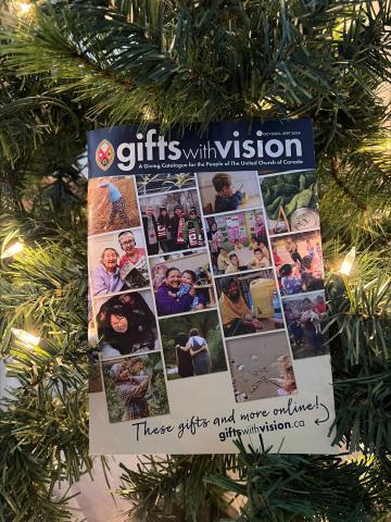 A Gifts with Vision catalogue in the branches of a Christmas tree