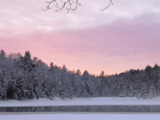 A lake partially covered by ice in winter