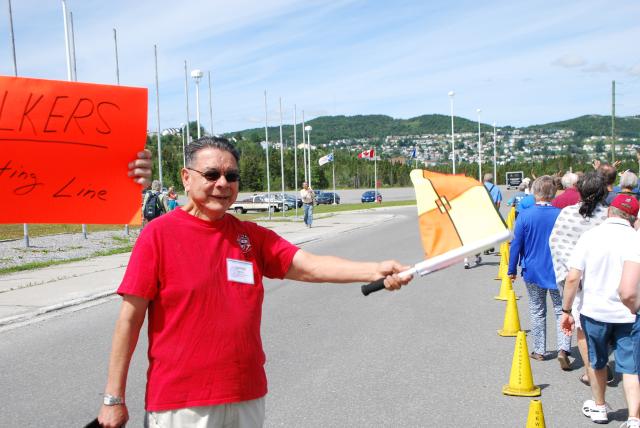 Indigenous elder Jim White holds a flag to start the Alvin Dixon Run at the 42nd General Council in Ottawa.