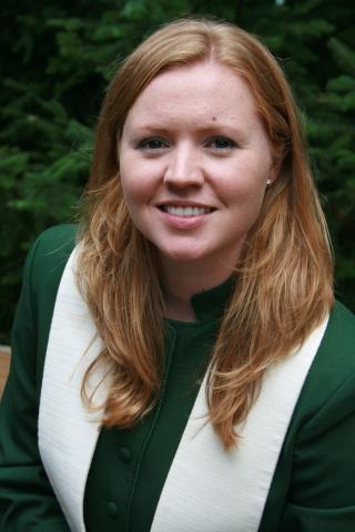 The author’s portrait from her first pastoral charge. She is a young woman with long blonde hair and is wearing a dark green jacket and white stole.