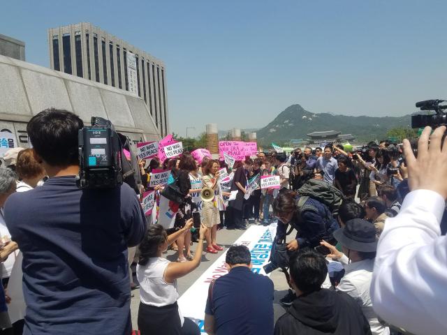 Participants in WomenPeaceKorea hold a press conference in Seoul.