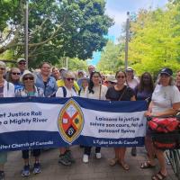 Members of the United Church hold a banner at the Grassy Narrows march in Toronto