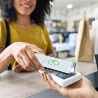 A woman makes a purchase using her phone