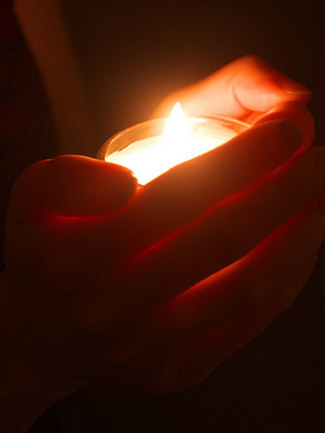 Hands holding a candle